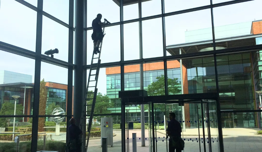 Clifton cleaning services window cleaner on a ladder cleaning windows.