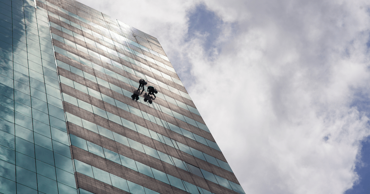 Man decending from high rise building, rope accesss.