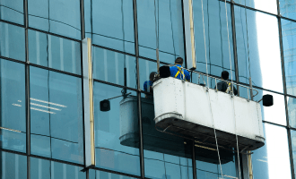 Men in a high level commercial window cleaning cradle.